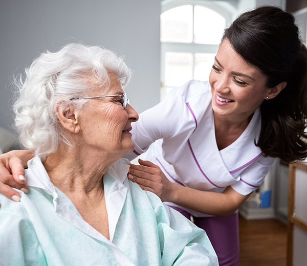 A photo of caring and professional assistance to her elderly patient