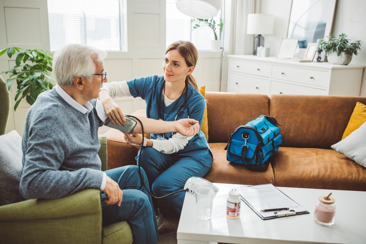 A photo of caring and professional assistance to her elderly patient